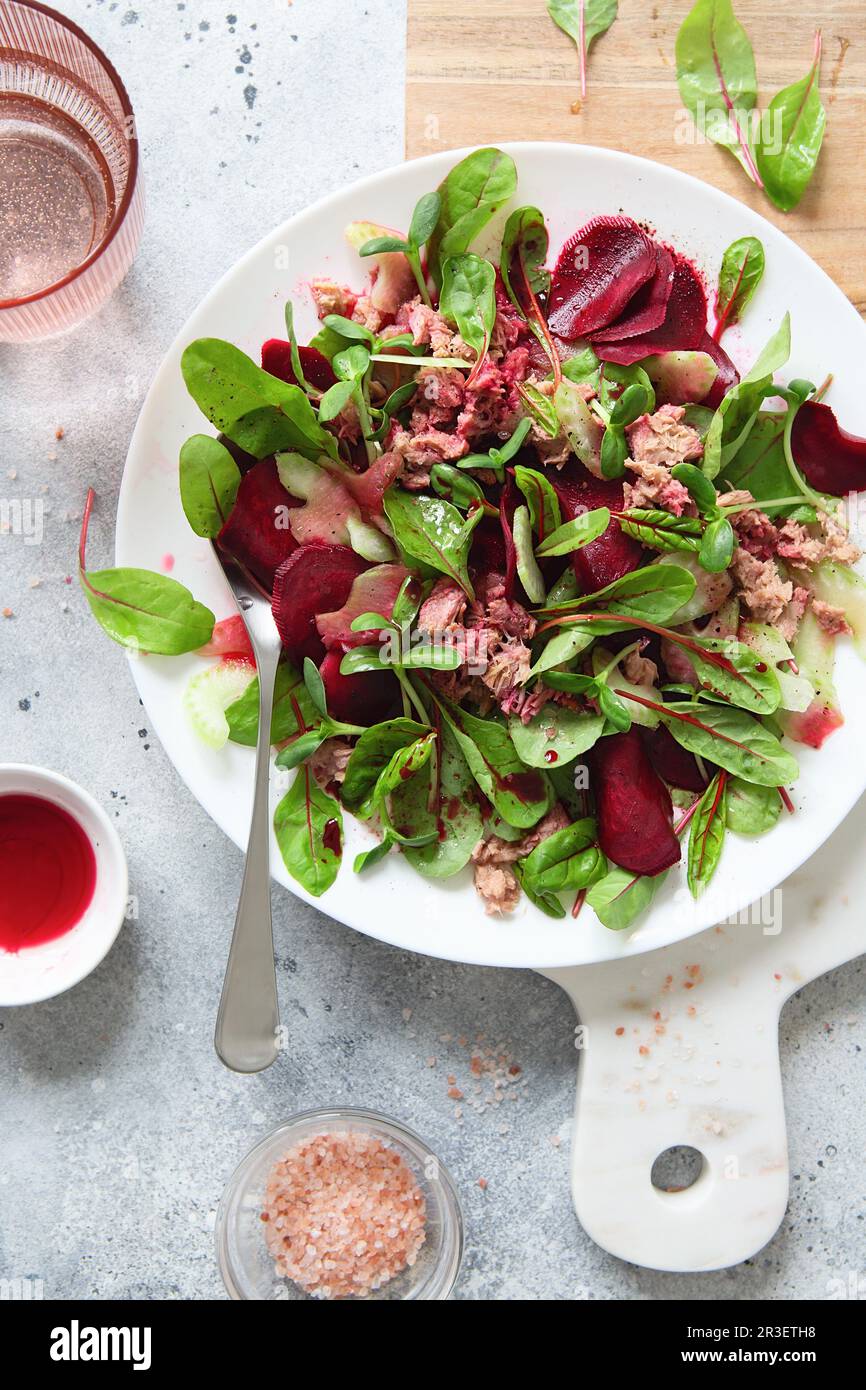 Healthy fresh salad. Beetroot, red chard and canned tuna salad. Healthy Meal recipe preparation. Plant-based dishes. Green livin Stock Photo