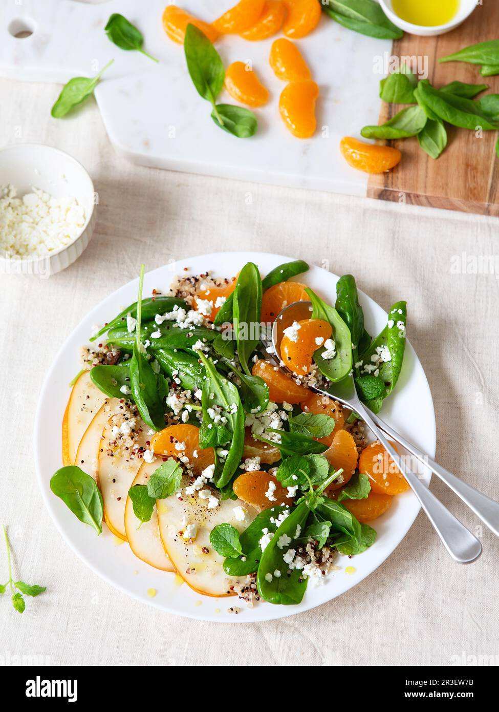 Spinach and quinoa salad with pears, oranges and ricotta. Healthy Meal prep. Plant-based dishes. Green living. Vegan recipe. Foo Stock Photo