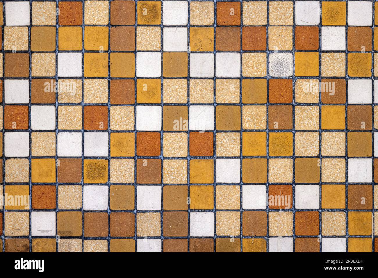 Background from a wall of brown, beige and ocre mosaic tiles Stock Photo