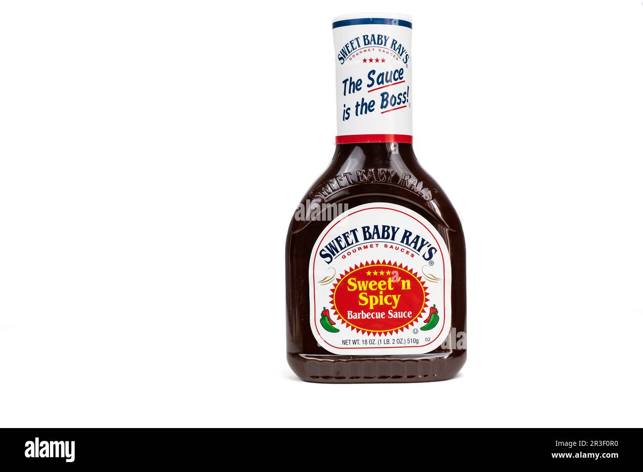 A bottle of Sweet Baby Ray's brand Sweet 'n Spicy Barbecue Sauce on white background. USA. Stock Photo