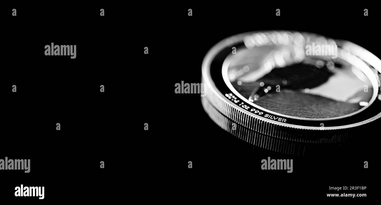 Close up of  Silver Bullion Coin on a black mirror background Stock Photo