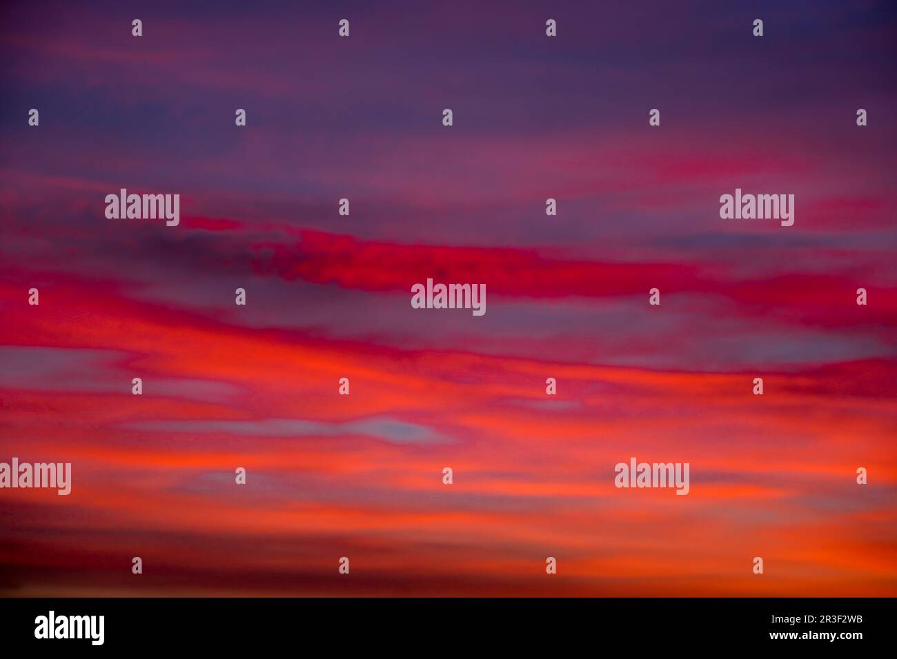 Vivid colourful clouds Dramatic Sky At Sunrise or Sunset. Orange red pink sky with beautiful clouds in sunlight background. Grad Stock Photo