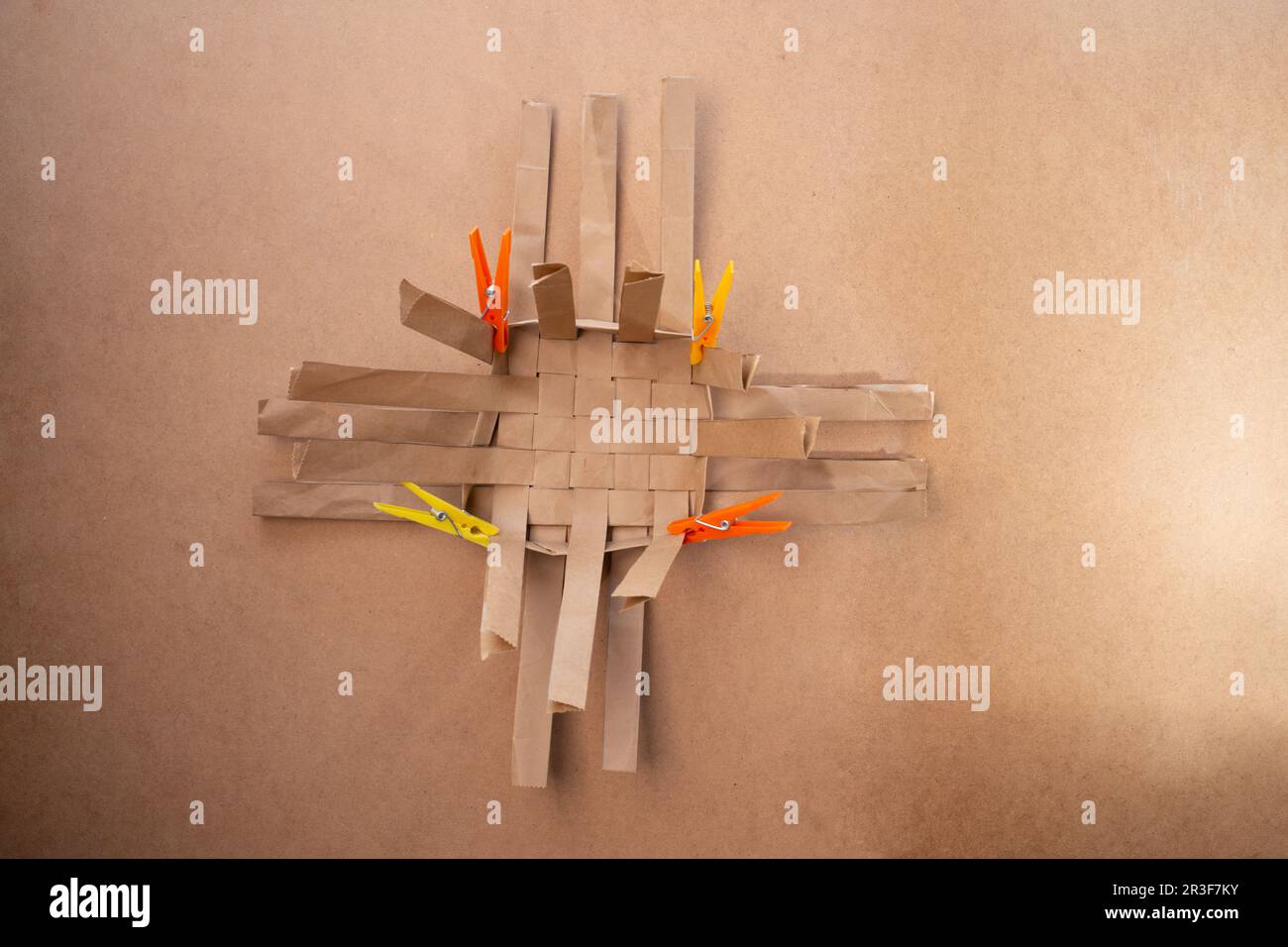 weaving paper strips fixed with clothespins, instructions for making a