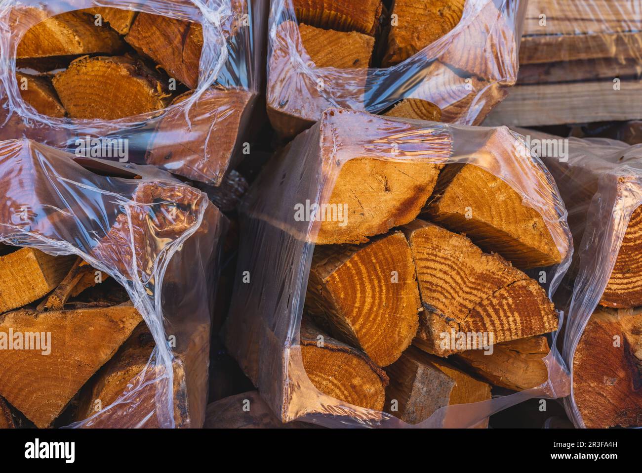 Dry firewood in plastic bags in the garden center. Hardwood for sale