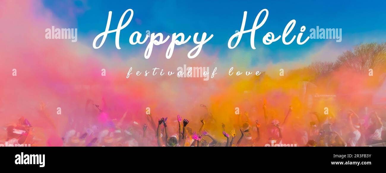 Crowd throwing bright colored powder paint in the air at Holi Festival Dahan Stock Photo