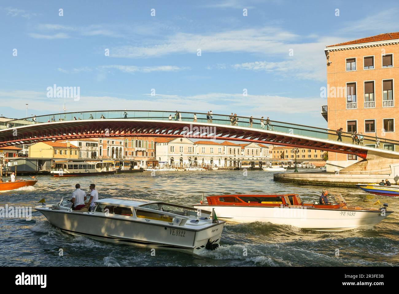 Motor boats on the Grand Canal under the Constitution Bridge, or Calatrava Bridge (2008), in summer, Venice, Veneto, Italy Stock Photo