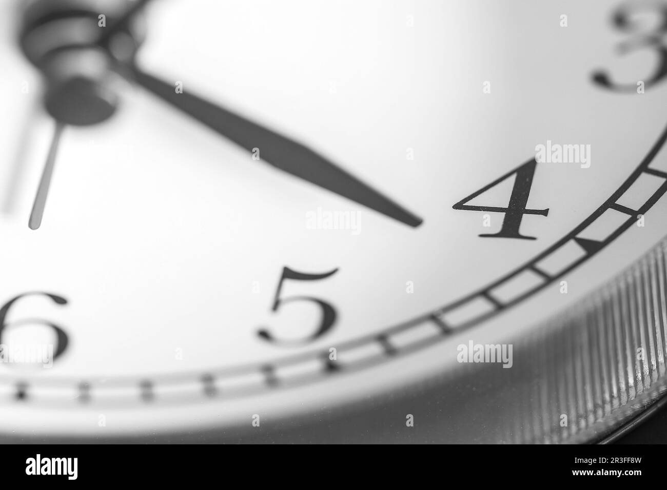 Clock hand pointing four o'clock on white clock face of Twin bell