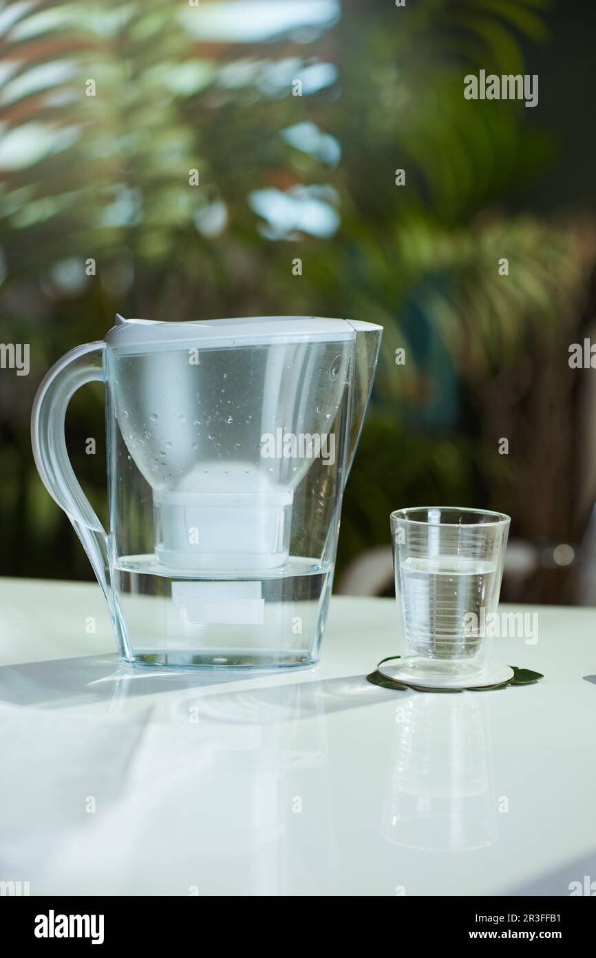 water filter and cup on the table in the modern office Stock Photo - Alamy