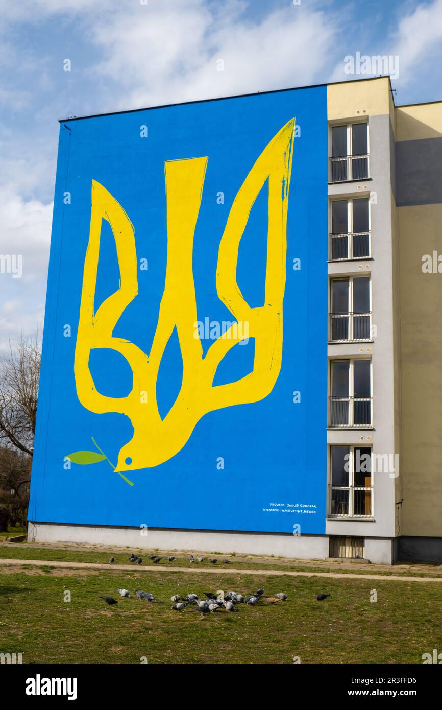 Gdansk Poland March 2022 UKRAINE national emblem with pigeon symbol of peace IN GRAFFITI. Mural painted in building house Poland Stock Photo