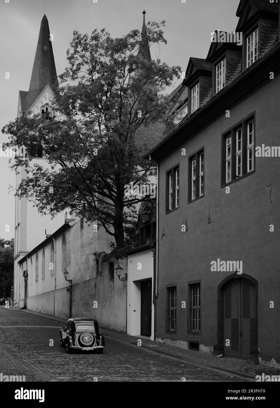 Black and White photo of the streets of Koblenz, Germany with no people and one solitary early 1900's vintage automobile, gives feeling of bygone era. Stock Photo