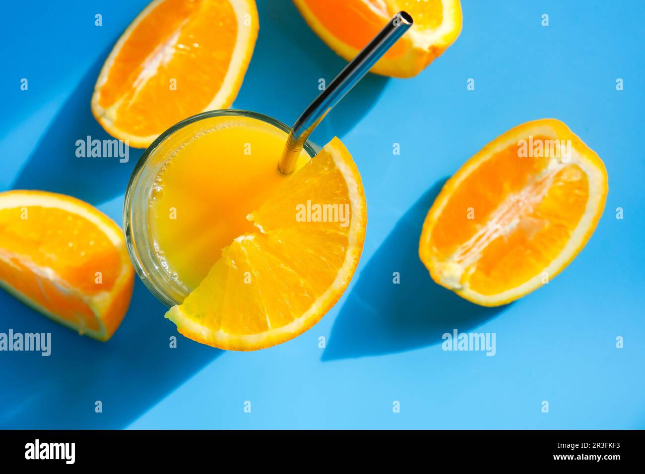 Glass of fresh squeezing Orange juice with eco metal drinking straw