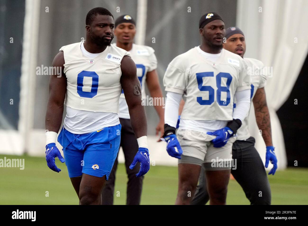 Los Angeles Rams linebackers Byron Young (0) and DeAndre Square (58