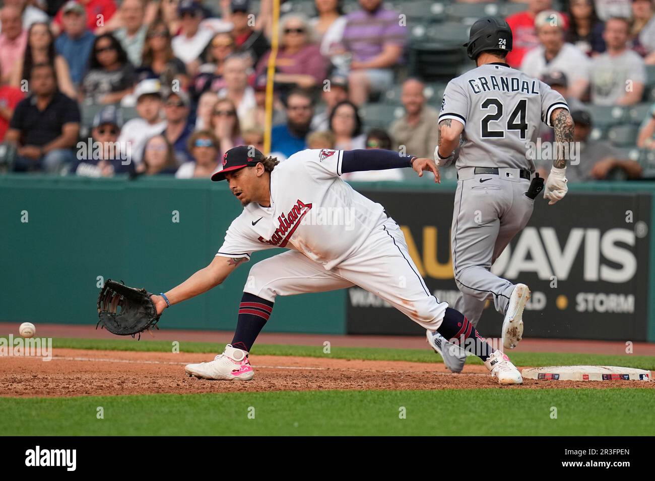 Cleveland Guardians first baseman Josh Naylor, left, reaches for the