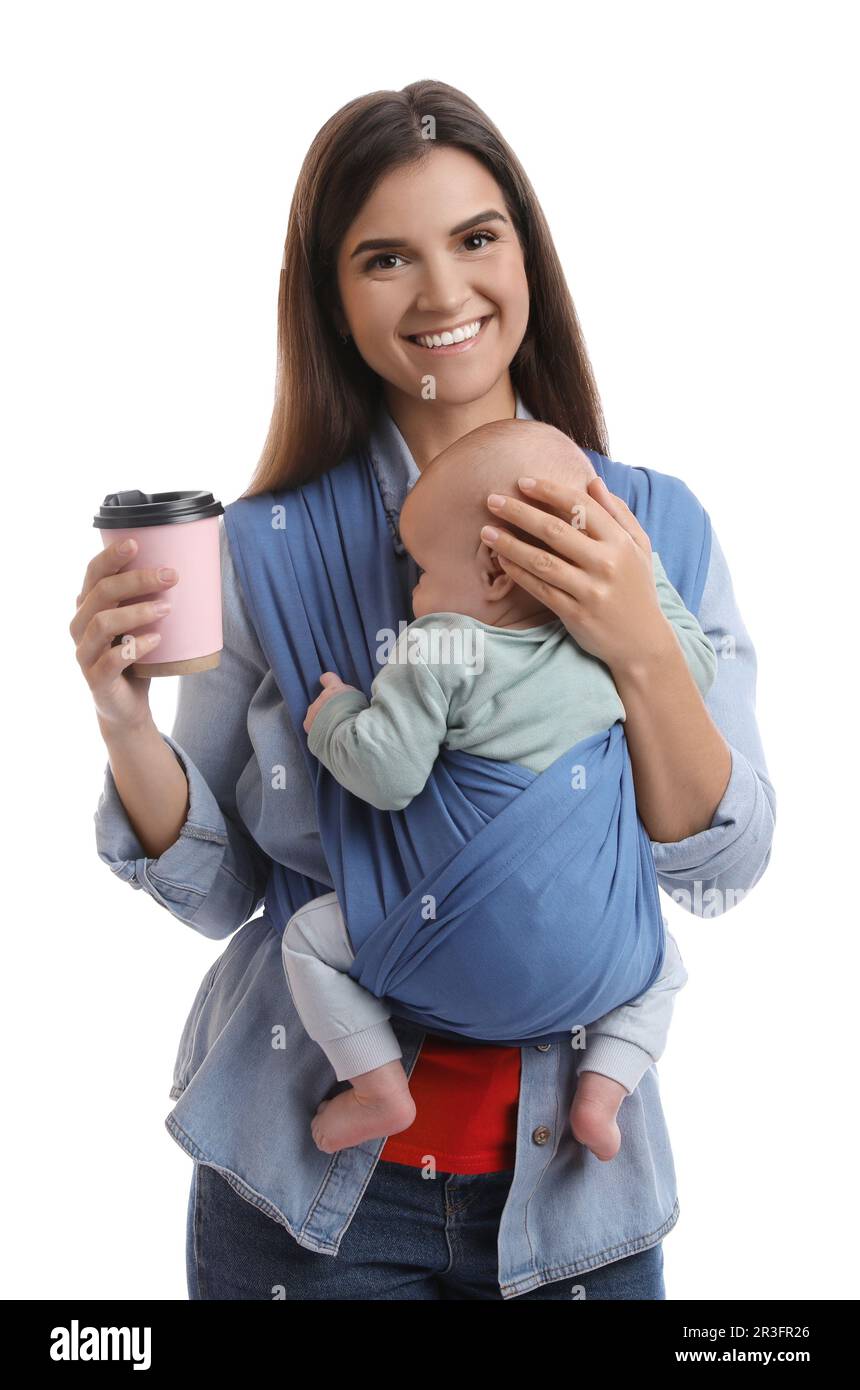 Mother with hot drink holding her child in sling (baby carrier) on