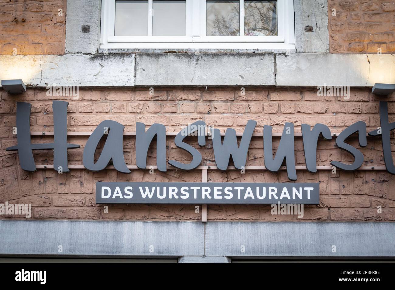 Picture of a sign with the logo of Hanswurst restaurant in aachen, germany. it's a german restaurant specialized in Wurst, or wursten, a symbol of Ger Stock Photo