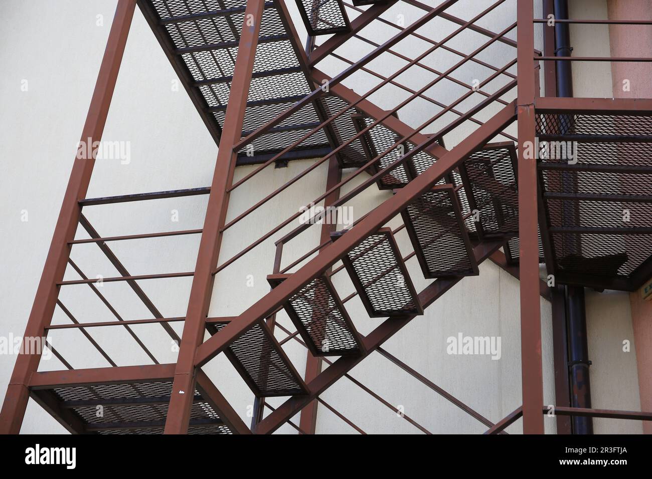 Metal fire escape ladder near building outdoors, low angle view Stock