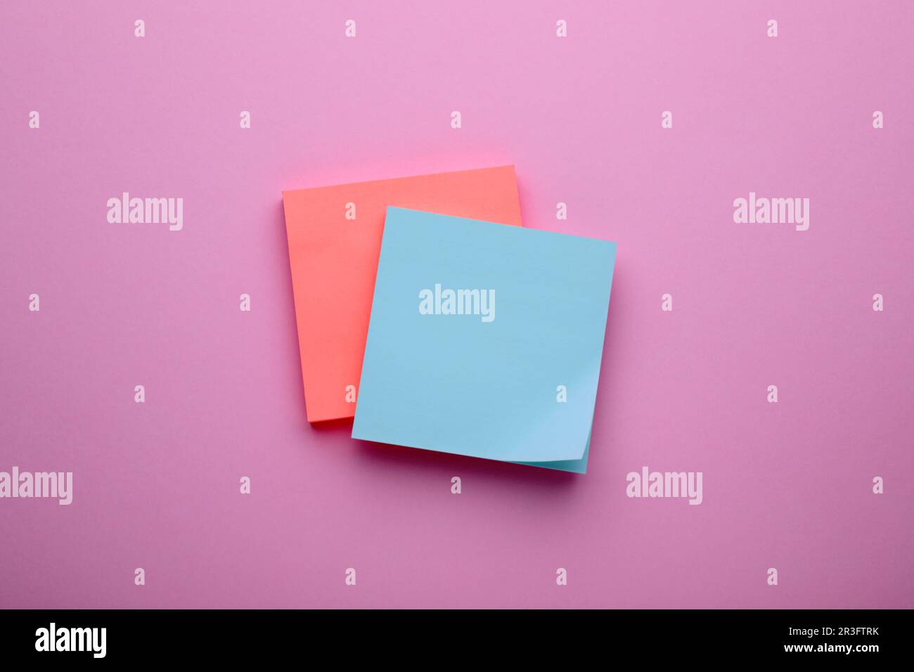 Paper notes on pale pink background, top view Stock Photo