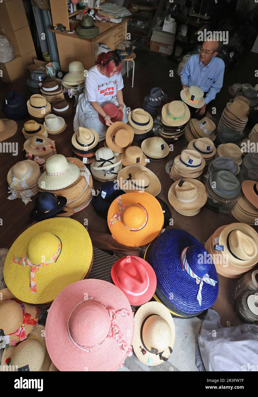 Colorful straw hats are ready to be shipped at Marutaka-seibosho, a hat  manufacturing factory, in Kannonji town, Kagawa Prefecture on May 23, 2022.  Japanese people wear straw hats to fight the humid