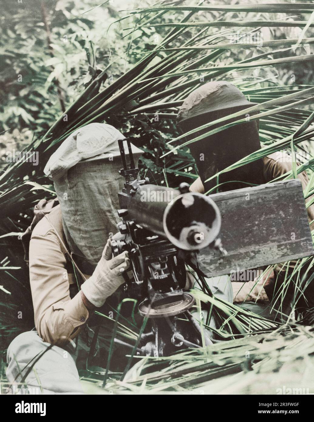 Machine gunners in the Caribbean area wearing head mosquito nets, circa 1942. Stock Photo