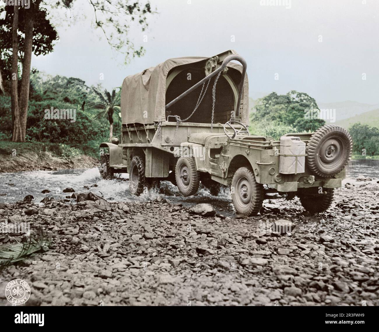 A U.S. military truck with wrecker mount towing a jeep, 1942. Stock Photo
