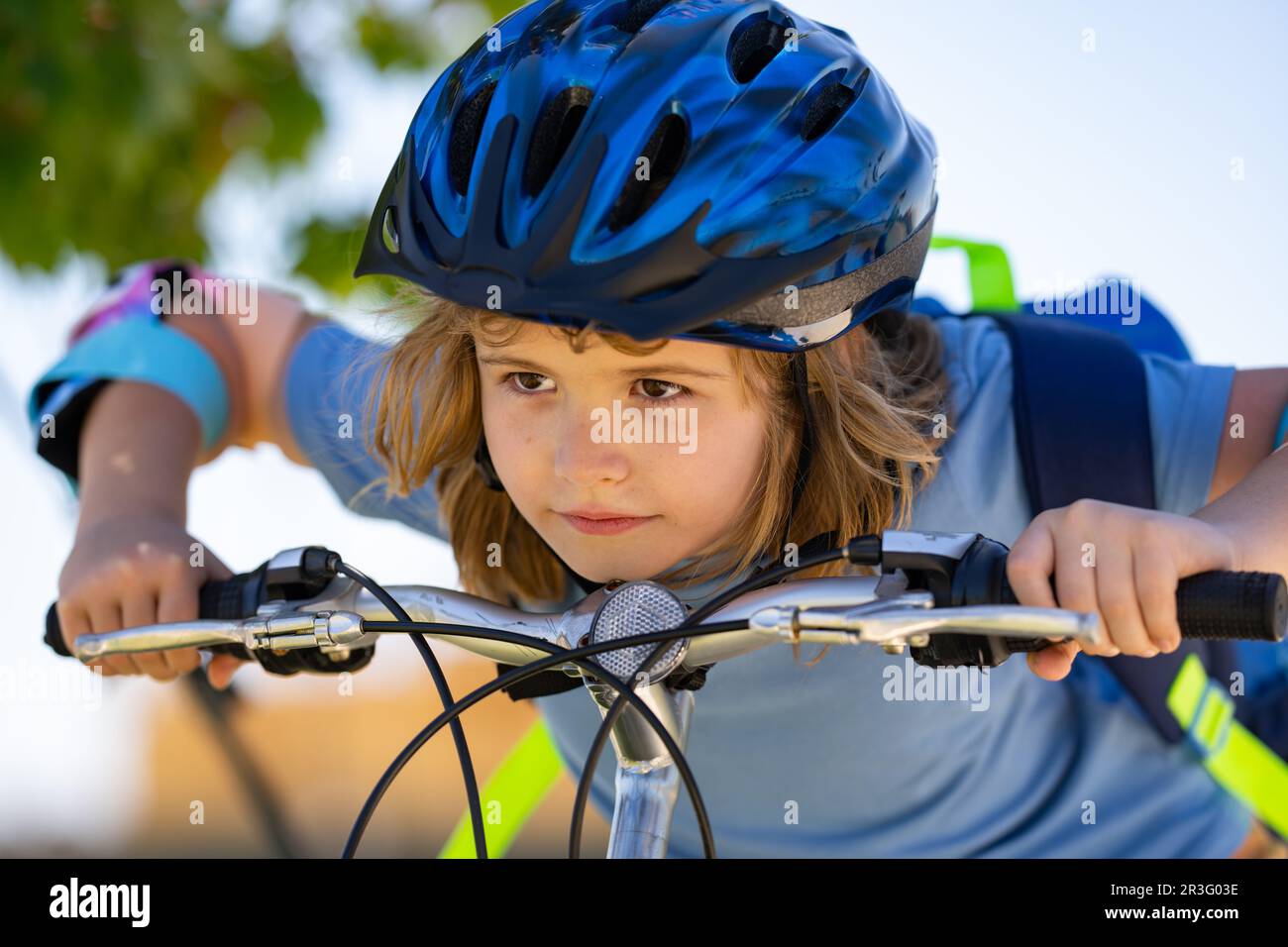 Boy in a helmet riding bike. Boy in safety helmet riding bike in city