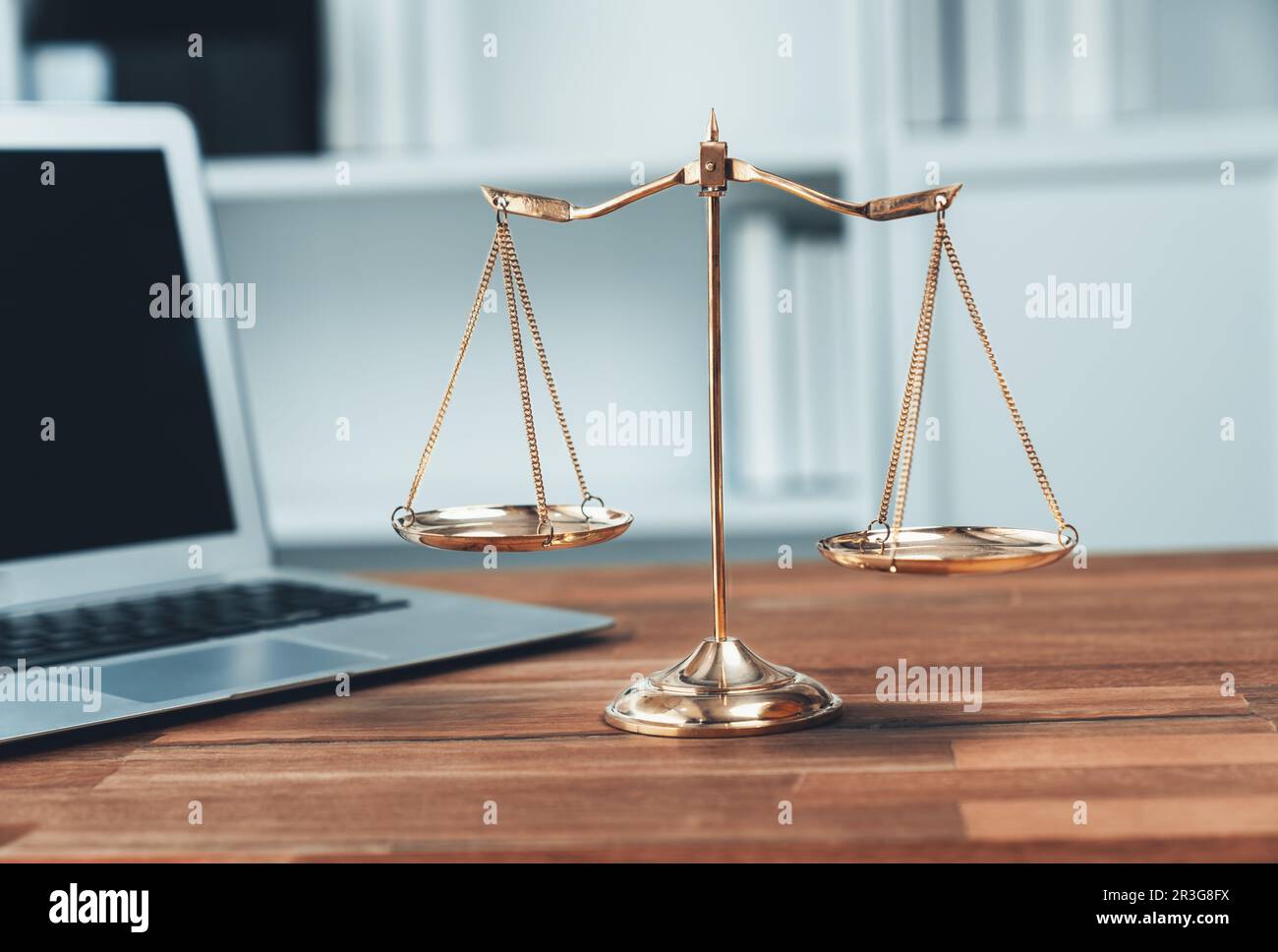 Symbolizing justice and legal authority, golden balanced scale on desk
