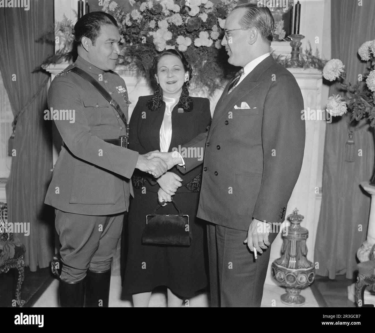 Cuban soldier and dictator Fulgencio Batista (left) shaking hands with Dr. Pedro Fraga at the Cuban embassy. Stock Photo
