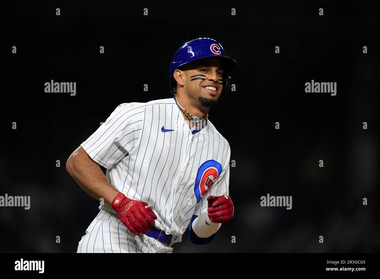 Chicago Cubs' Christopher Morel smiles as he runs the after hitting a