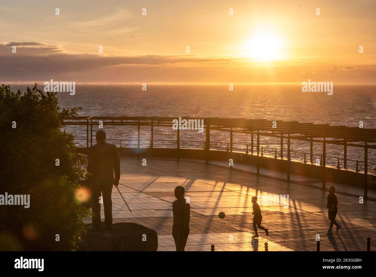 Kids play football in a city park by the sea, Playa San Juan, Tenerife, Canary Islands, Spain Stock Photo