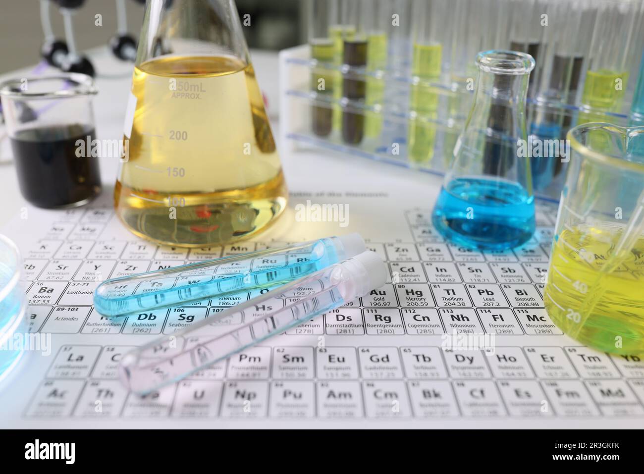 Glass flasks and test tubes with liquid on Mendeleev table Stock Photo ...