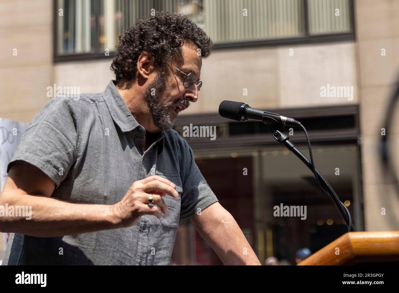 New York City, USA. 23rd May, 2023. Author and playwright Tony Kushner speaks of the shamelessness of corporate greed. The Writers Guild of America-East (WGA) is on strike against the Alliance of Motion Picture and Television Producers for better contract and residual rights, and held a rally on May 23, 2023, of several thousand people at Rockefeller Center (30 Rock) in New York City. (Photo by John Rudoff/Sipa USA) Credit: Sipa USA/Alamy Live News Stock Photo