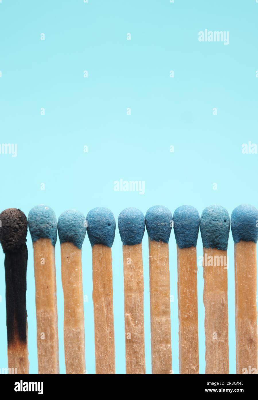 Matches against a blue background, one burned out, career or health care concept Stock Photo
