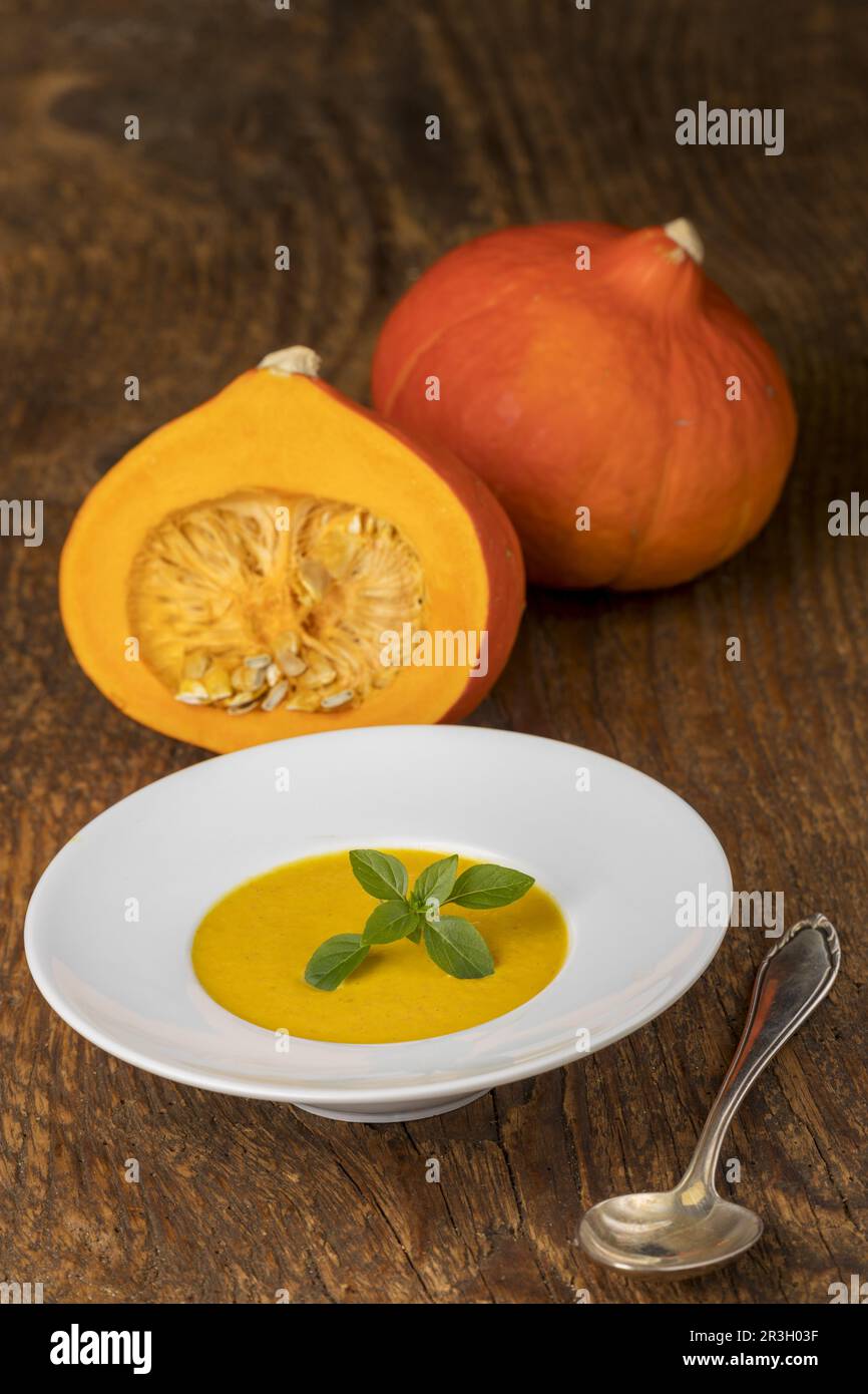 Pumpkin soup on white wood background Stock Photo - Alamy