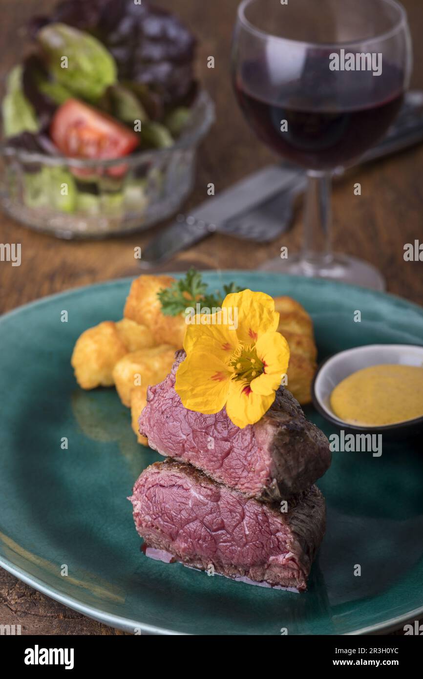 Steak with croquettes on wood Stock Photo