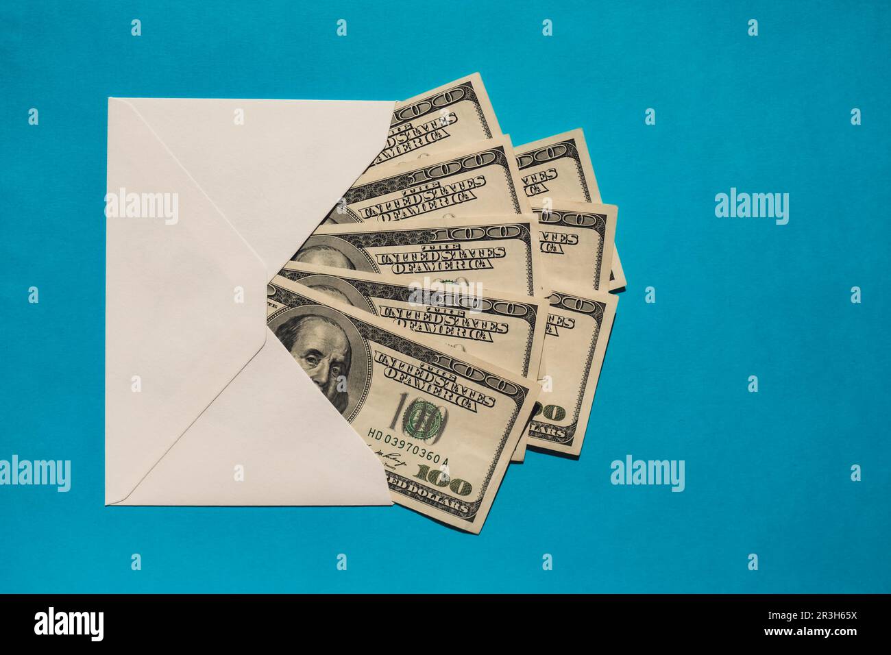 Dollar banknote saving money in envelope on blue background copy space. Consumption and economy Collecting money. Tips. Business Stock Photo