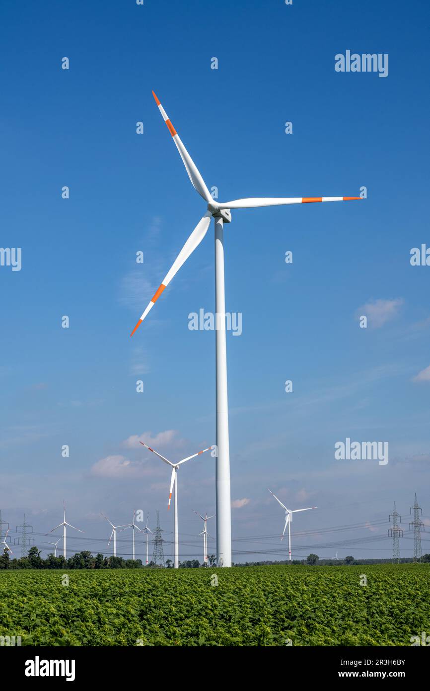 Wind turbines with power lines on a beautiful sunny day in Germany ...