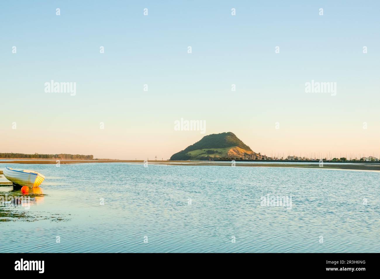 Landmark Mount Maunganui on distant horizon at sunrise with old