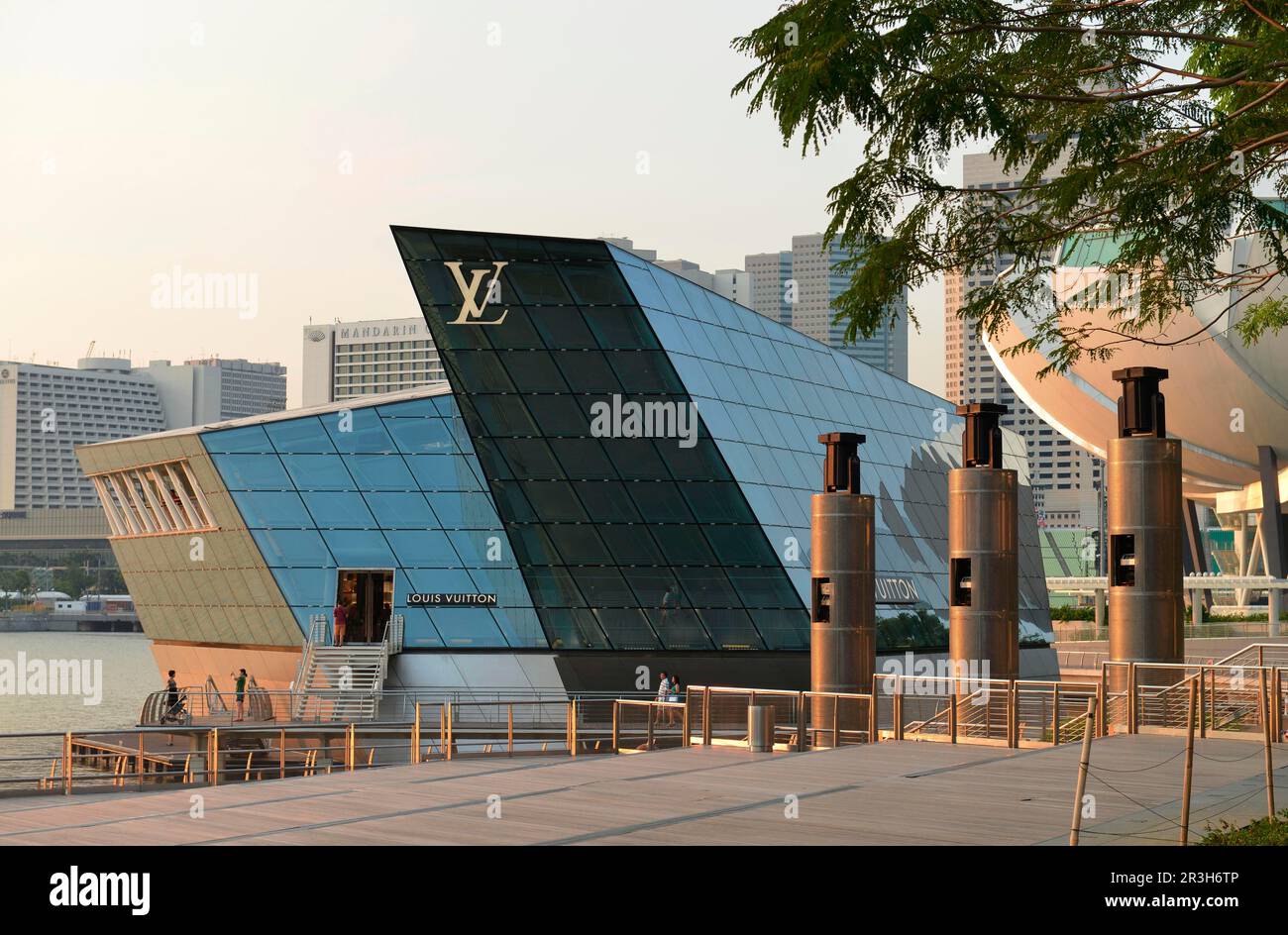 Singapore, Republic of Singapore, Asia - Louis Vuitton luxury boutique at Marina  Bay with the city skyline of the central business district in the bac -  SuperStock