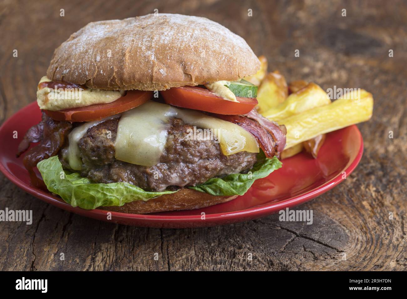 Cheeseburger with fries on wood Stock Photo
