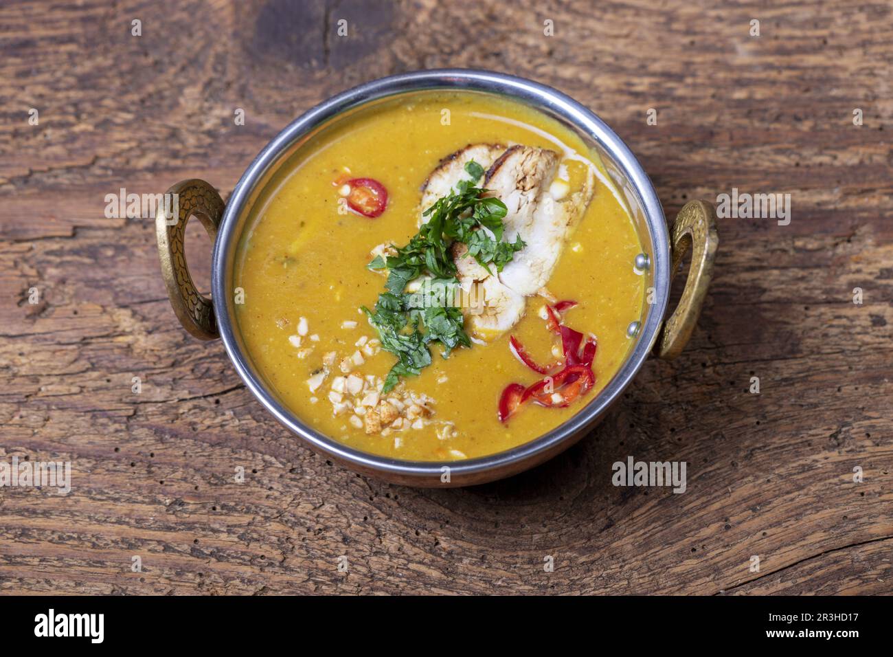 Indian mulligatawny soup in a brass bowl Stock Photo