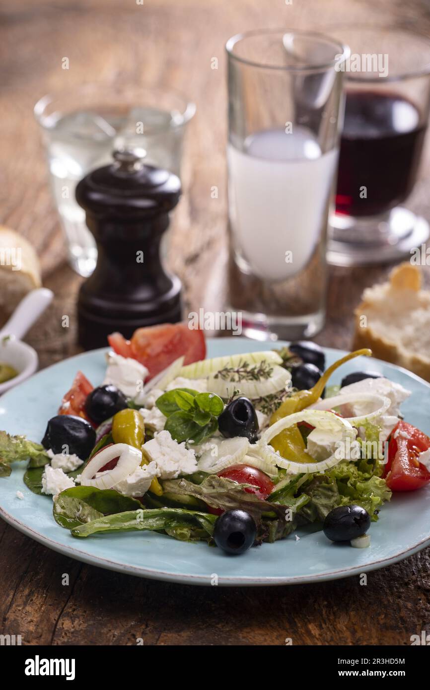 Greek salad on dark wood Stock Photo