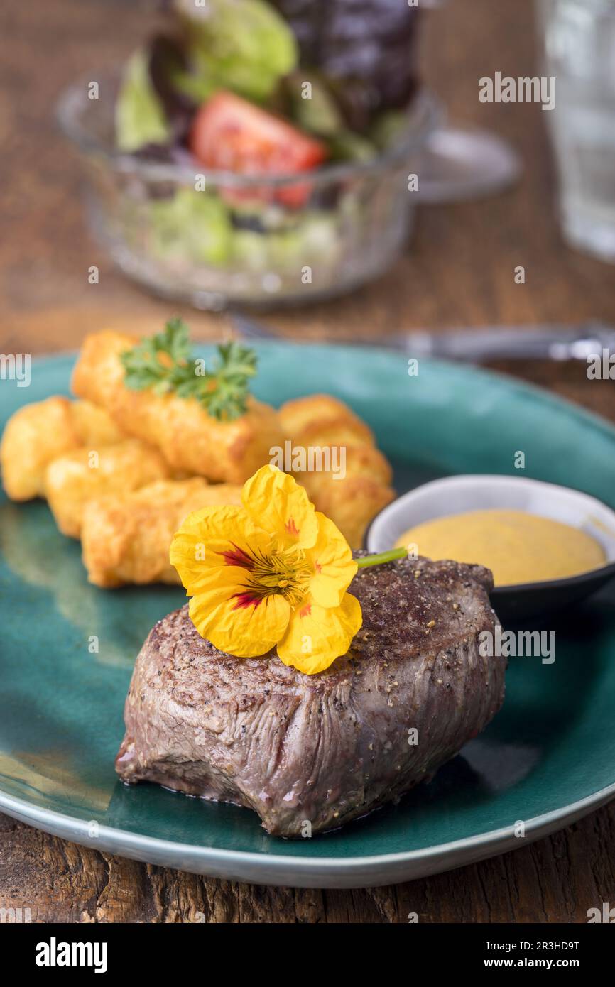 Steak with croquettes on wood Stock Photo