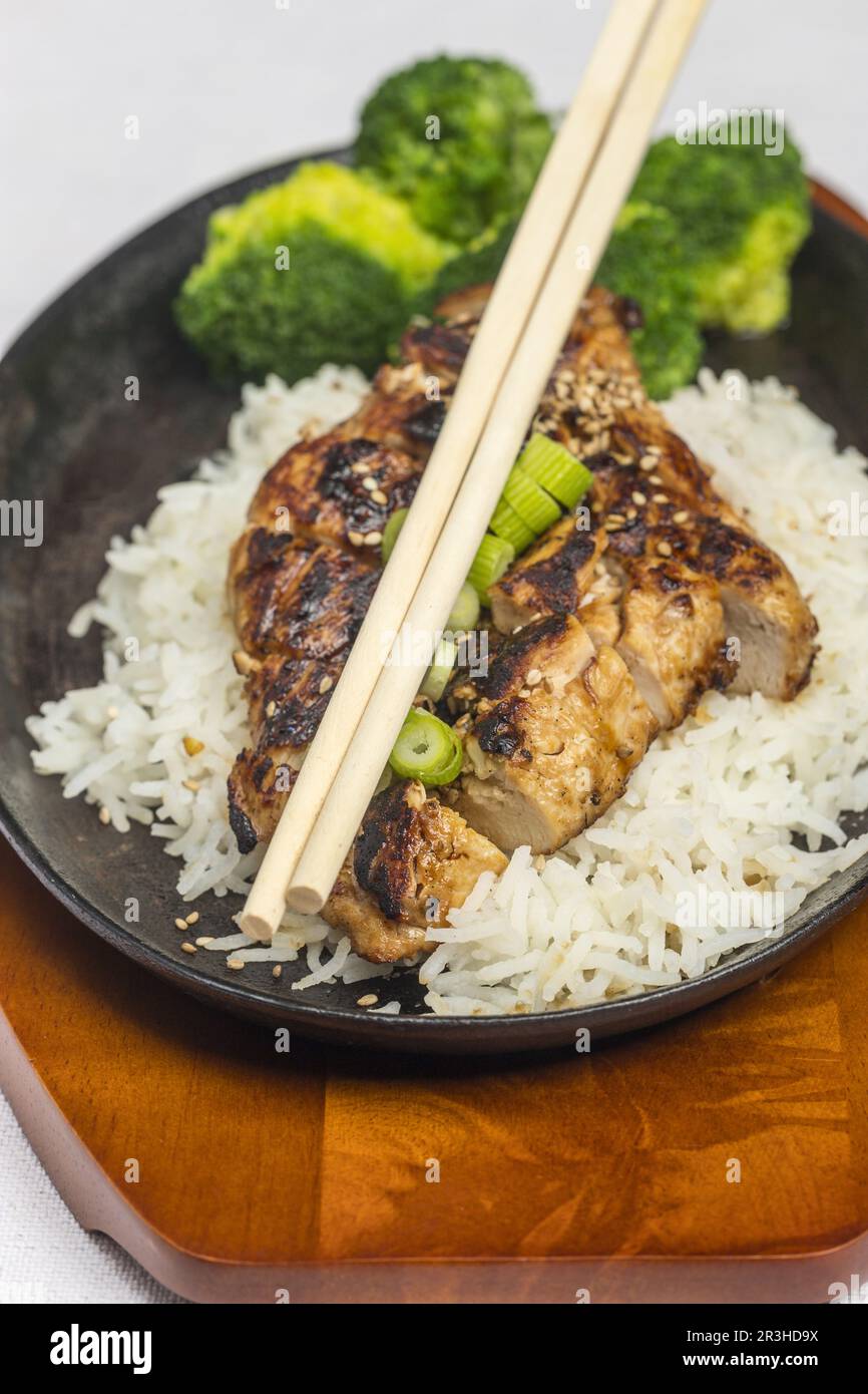 Teriyaki chicken on rice in a brutzler Stock Photo