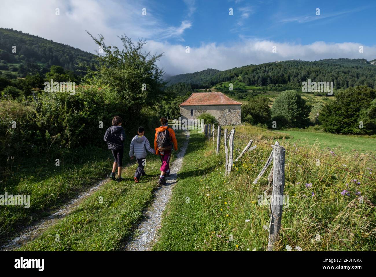 escursionistas frente a la ermita de Arrako, valle de Belagua, Isaba, Navarra, Spain, Europe. Stock Photo