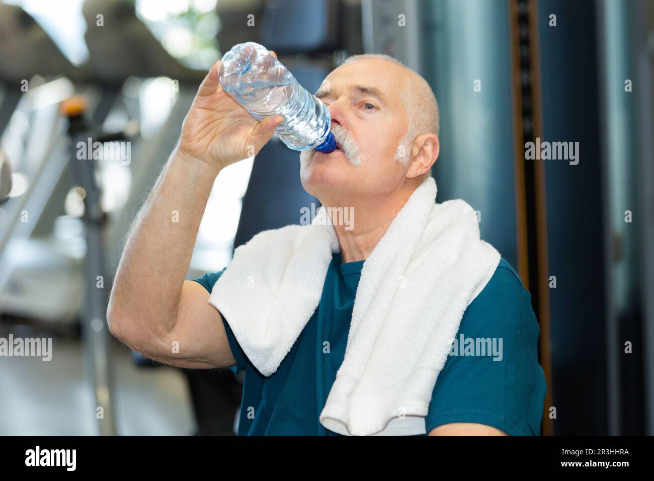 senior man drinking water in the gym Stock Photo - Alamy
