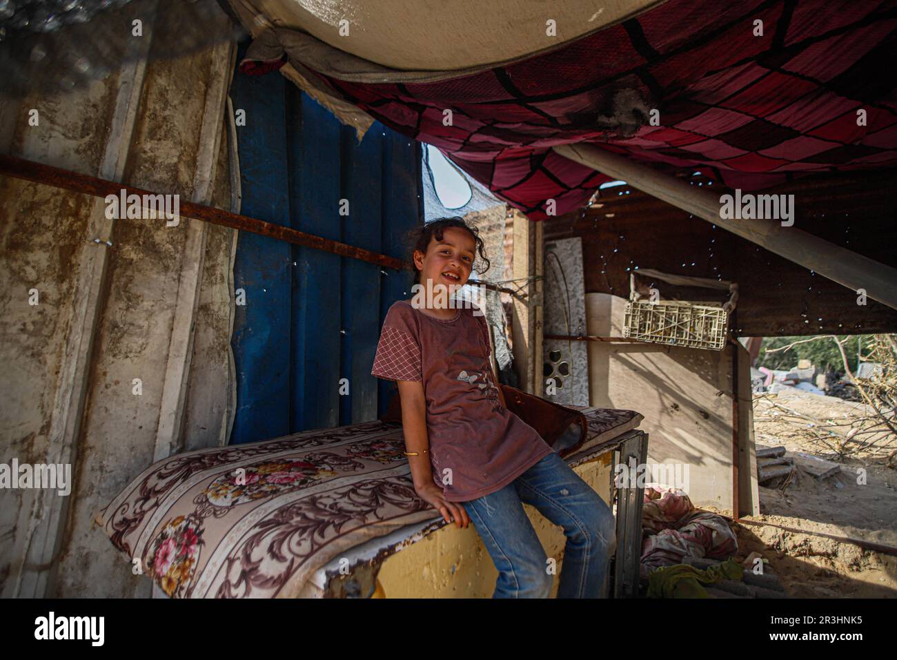Palestine. 23rd May, 2023. A Palestinian man sits with his son next to ...
