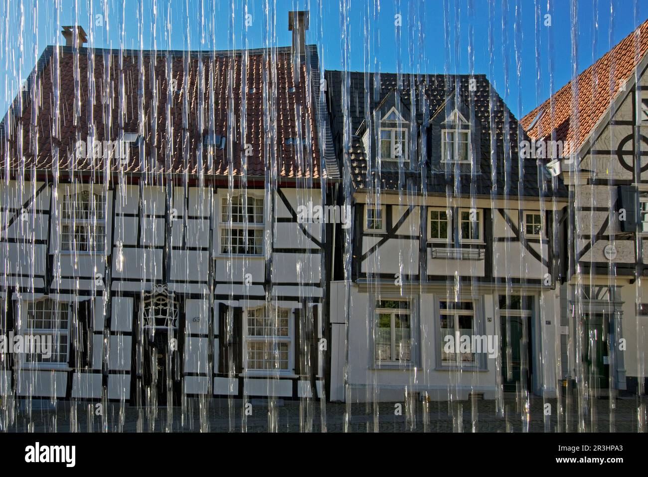 Half-timbered houses behind water from the Weberbrunnen on Tuchmacherplatz, Kettwig, Essen, Germany Stock Photo