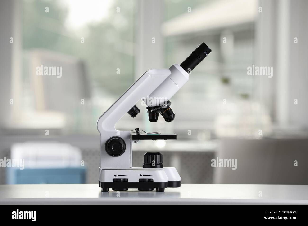 Modern medical microscope on white table in laboratory Stock Photo - Alamy