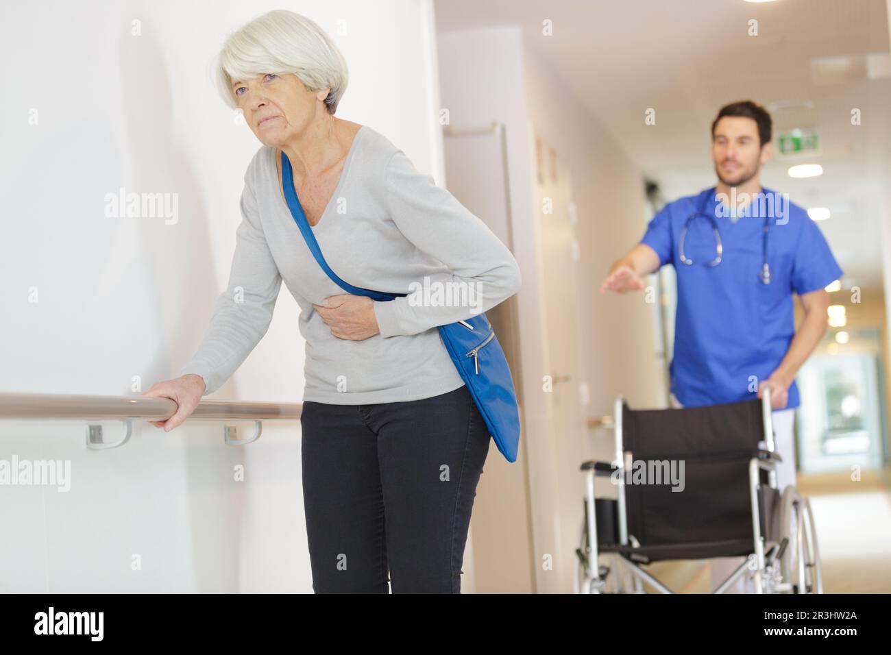old woman needing help from nurse in hospital Stock Photo