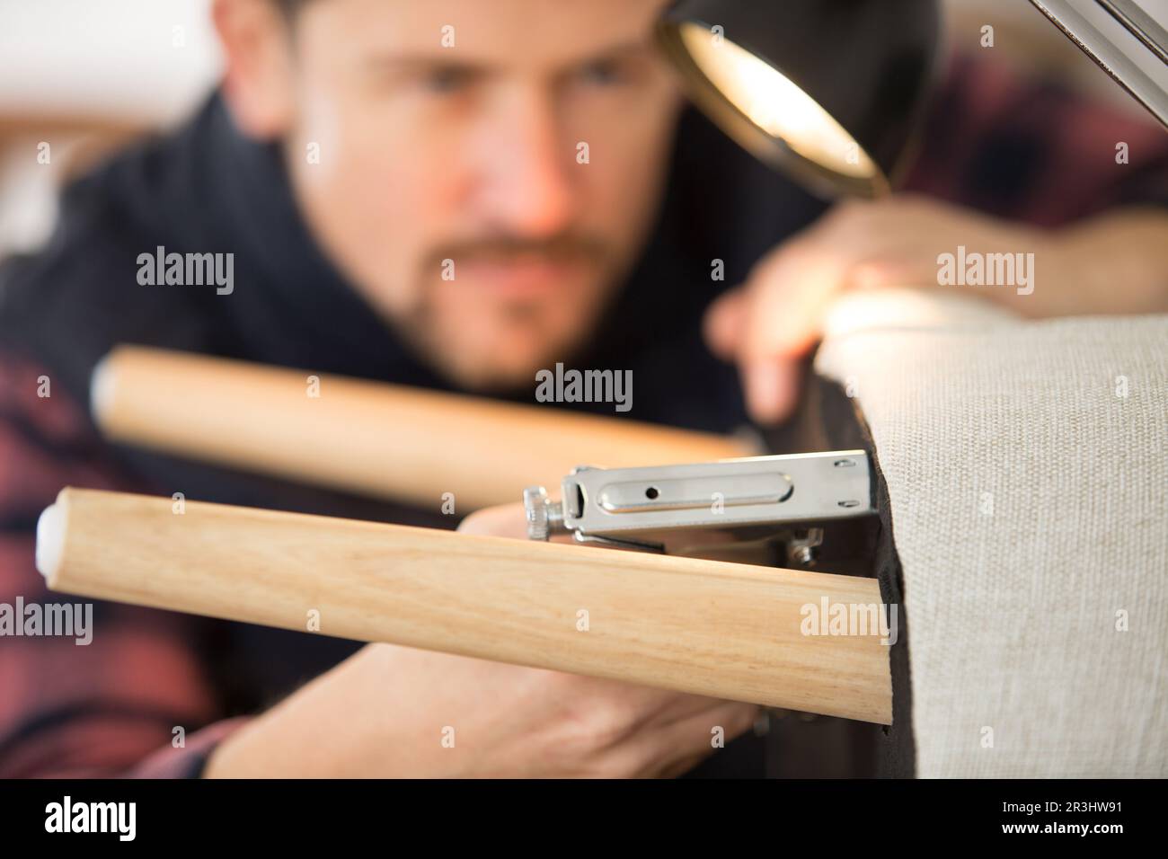 upholstery man using stapler to fix stool Stock Photo Alamy